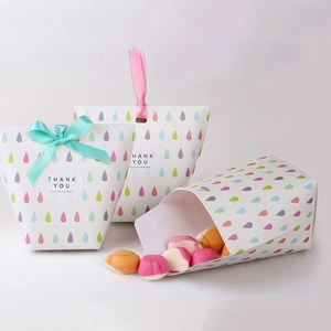 Detail of white foldable gift box with colorful teardrop patterns and satin ribbons