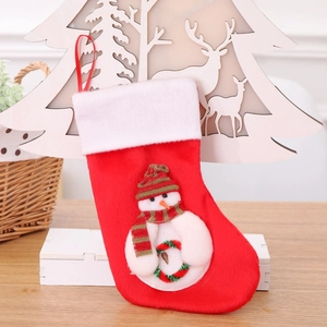 Red plush 21cm Christmas stocking with 3D snowman applique on a rustic wooden background