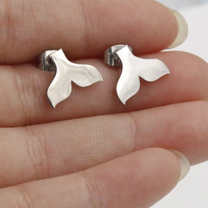 Polished silver stainless steel mermaid fishtail stud earrings for women on display