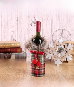 Detail of Christmas wine bottle cover with red-green plaid fabric and faux fur collar