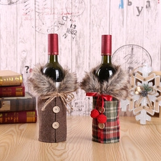 Detail of Christmas wine bottle covers featuring plaid patterns and plush collars decorations