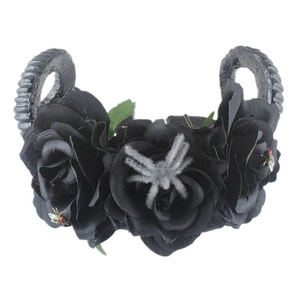 Detail of gothic flower headband with black roses, ram horns and a plush spider
