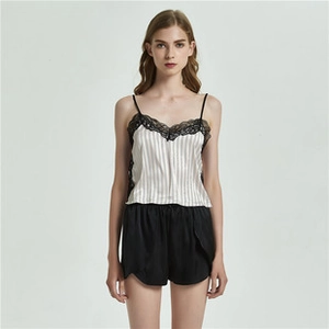 Detailed view of women's silk camisole with grey vertical stripes and black lace trim