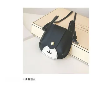 Detail of a kids panda-style mini crossbody bag featuring a golden magnetic clasp