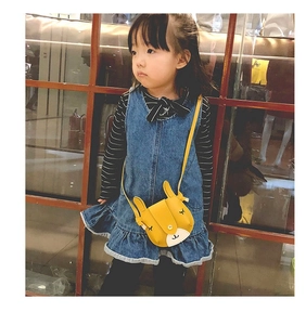 Girl wearing yellow rabbit-shaped cartoon crossbody bag with leather texture detail