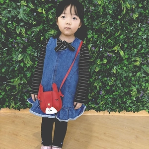 Cute red bunny toddler crossbody bag paired with striped top and denim ruffle dress