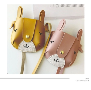 Detail of cute rabbit crossbody bags for kids in yellow and pink faux leather material
