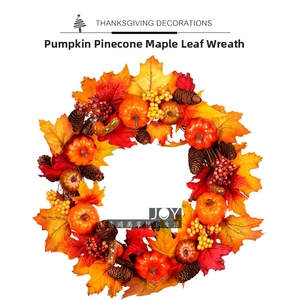 Detailed close-up of Thanksgiving wreath with faux pumpkins, pinecones, and maple leaves