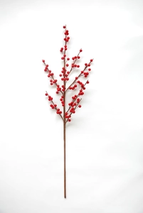 Close-up of lifelike artificial red winterberry stems with shiny berries for holiday decor