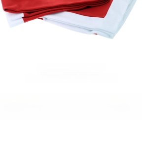 Detail of red and white non-woven Christmas chair cover fabric with festive zigzag trim