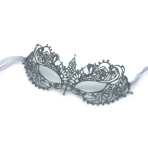 Detailed view of silver lace phoenix mask with glitter finish and ribbon ties