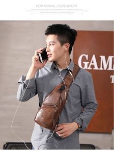 Brown leather sling bag for men featuring multiple zipper compartments and USB port