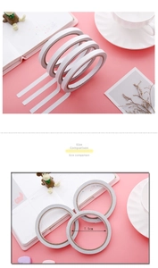 Detailed view of 7.5cm diameter white double-sided adhesive tape rolls on pink background