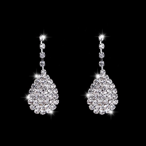 Detailed macro view of silver teardrop earrings with sparkling crystal rhinestones for weddings