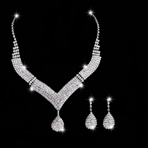 Silver bridal jewelry set with V-shaped rhinestone necklace and teardrop earrings