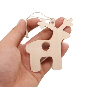 Handheld view of a wooden elk pendant with heart cutout for festive home decoration