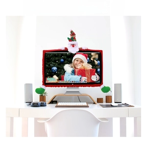 Close-up of a festive red plush computer monitor cover featuring a 3D Santa Claus doll
