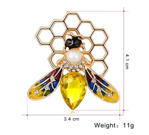 Detailed size view of an enamel bee brooch with yellow main stone and honeycomb design