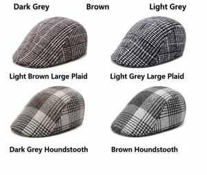 Close-up of winter flat caps in four different plaid patterns and wool fabric textures