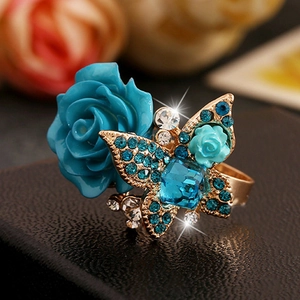 Macro shot of bohemian rose ring with blue crystals and a butterfly on alloy band