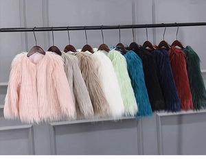 Selection of colorful faux fur coats for girls hanging in various vibrant shades