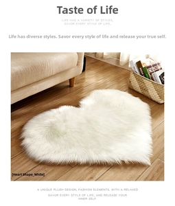 Plush heart-shaped white faux fur rug on warm wood floor in a cozy living room setting