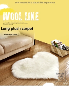 Close-up of white heart-shaped shaggy rug with high-density plush texture on wooden floor