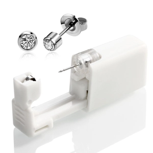 Detail of disposable piercing tool with 4mm cubic zirconia stud and white applicator