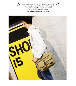 Khaki canvas messenger bag with multi-pocket design shown on street-style model