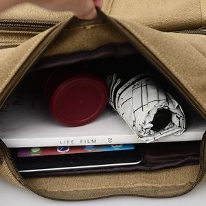 Large khaki canvas crossbody bag interior showing storage for iPad and daily essentials