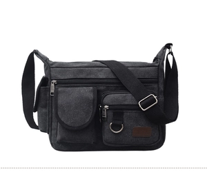 Detail view of durable canvas chest bag with multiple zipper pockets and ZETA leather patch