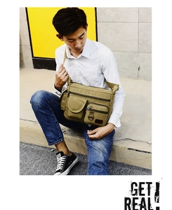 Asian male model wearing a large capacity khaki canvas messenger bag with multi-pockets