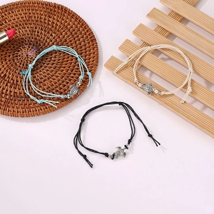 Set of 3 handmade woven sea turtle anklets with light blue, cream, and black wax cords