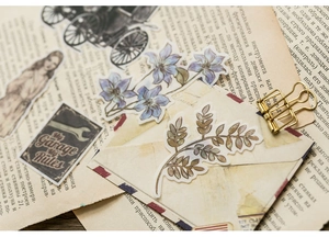 Macro view of vintage floral and botanical stickers on antique paper background
