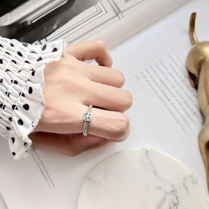 Detailed view of an S925 sterling silver wavy band ring featuring a retro smiley face