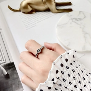 Detailed view of S925 sterling silver smile face ring with twisted rope band on finger
