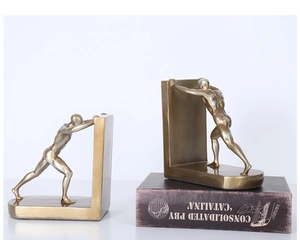 Detail of creative golden muscular athlete bookends showing artistic dynamic body texture