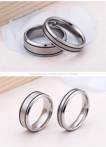Detail view of brushed titanium steel couple rings with parallel black striped grooves
