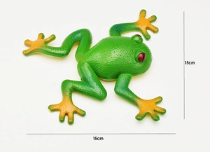 Top view of 15cm green realistic frog toy with red eyes and orange feet on white background