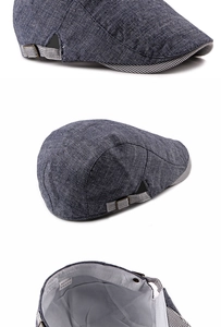 Detail of blue-gray cotton linen flat cap showing striped adjustable side strap and buckle