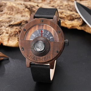 Detail of wooden sports watch dial featuring a functional compass and unique rotary time display