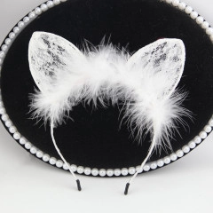 Detail of white lace cat ear headband with soft feathers and bow on black display