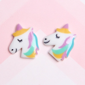 Close-up of colorful resin unicorn head charms for DIY phone case making and crafts