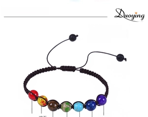 Macro detail of 8mm chakra beads and adjustable woven cord on lava rock yoga bracelet