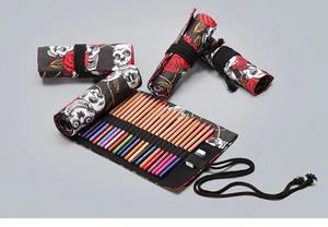 Detail of printed canvas pencil roll featuring skull and rose patterns with elastic loops