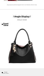 Détail du sac cabas en cuir grainé noir avec doublure rose et pendentif chat doré