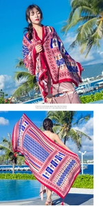 Detailed view of bohemian red cotton scarf with ethnic prints and decorative fringes