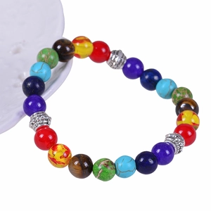 8mm Seven Chakra natural stone yoga bracelet with silver spacers on a white background