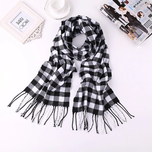 Detailed view of classic black and white checkered scarf featuring soft tassel edges