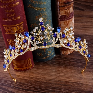 Vue détaillée d'une couronne de mariée dorée avec saphirs bleus sur des livres anciens
